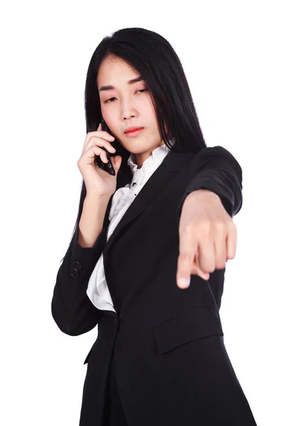 Young business woman talking with mobile phone and pointing isol — Stock Photo, Image