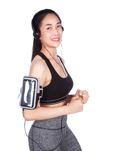 Fitness mujer corriendo y escuchando música sobre fondo blanco —  Fotos de Stock