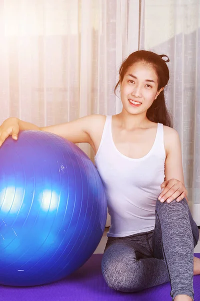 Žena dělá jóga cvičení s fitness míčem — Stock fotografie