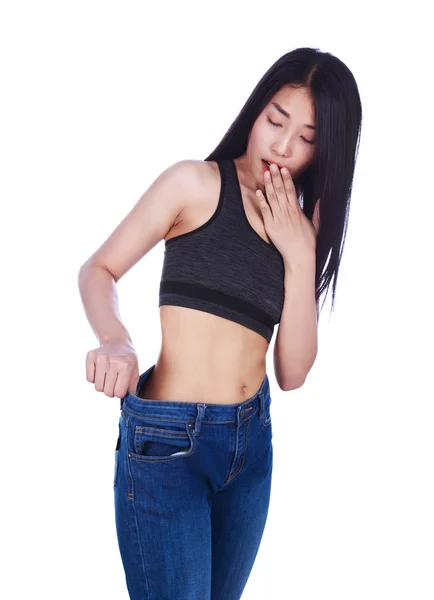 Shocked slim fitness woman in old jeans after losing weight isol — Stock Photo, Image