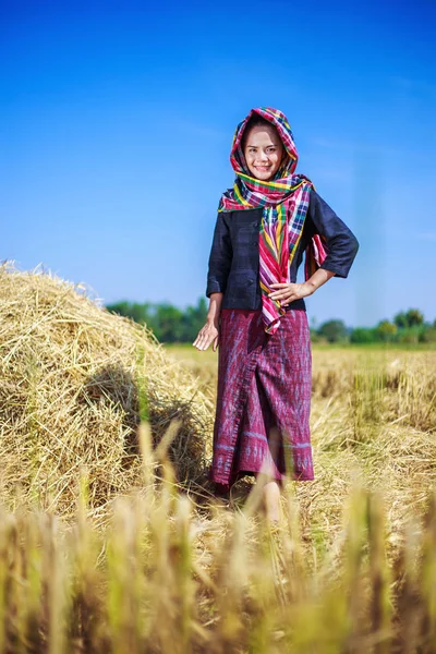 Beautiful farmer woman with the straw in field — Stock Photo, Image