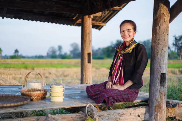 farmer woman sitting in cottage at rice field