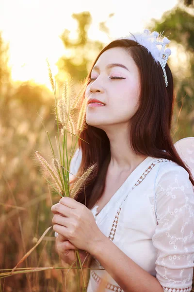 angel woman in a grass field with sunlight