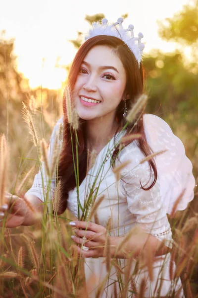 Angel woman in a grass field with sunlight — Stock Photo, Image
