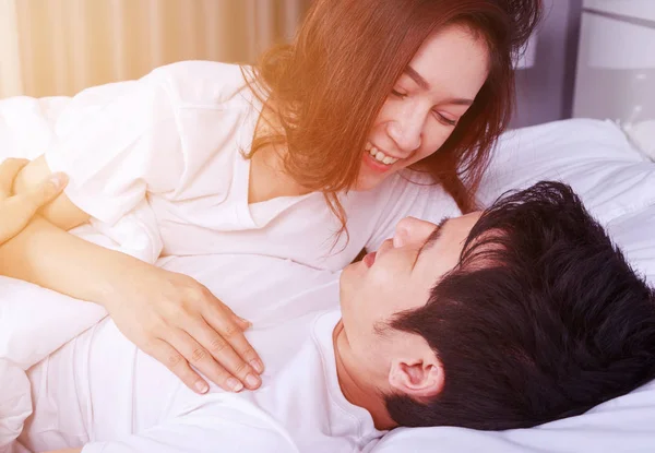 Lovely couple lying in a bed and looking to each other (eyes to — Stock Photo, Image