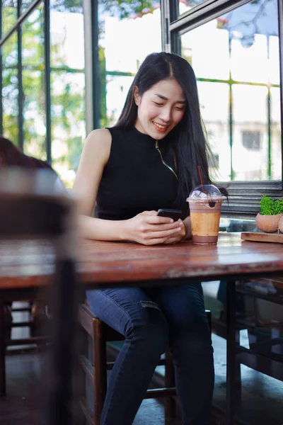 Женщина с помощью смартфона в кафе — стоковое фото
