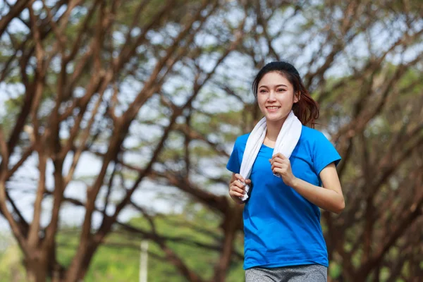 beautiful fitness woman running in park