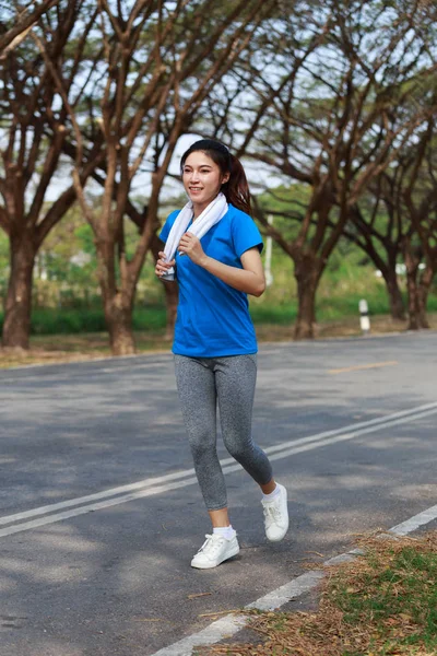 Beautiful fitness woman running in park — Stock Photo, Image