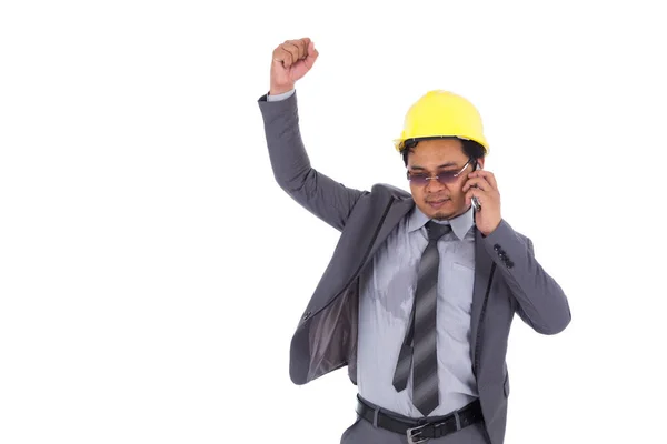 Happy engineer talking on smartphone with arm raised isolated on — Stock Photo, Image