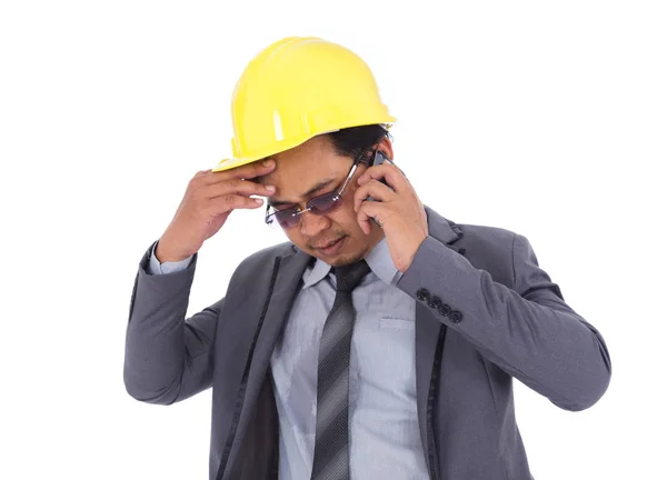 Engineer receiving bad news on the cell phone isolated on white — Stock Photo, Image