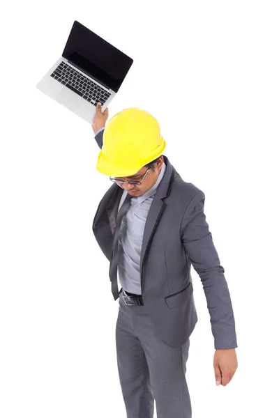 Very angry engineer is throwing away his laptop isolated on whit Stock Picture