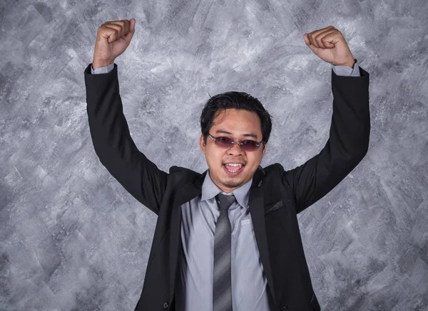 Winner business man in suit with arms raised — Stock Photo, Image