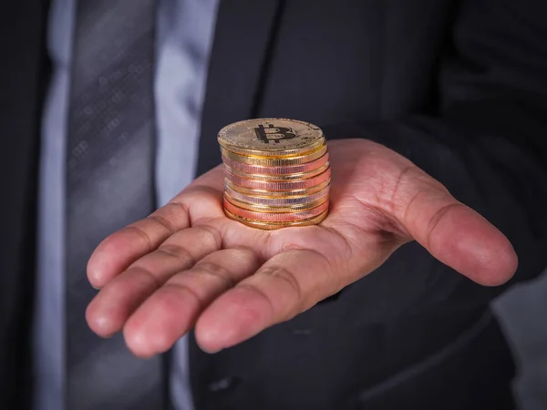 Bitcoin in hand of business man — Stock Photo, Image