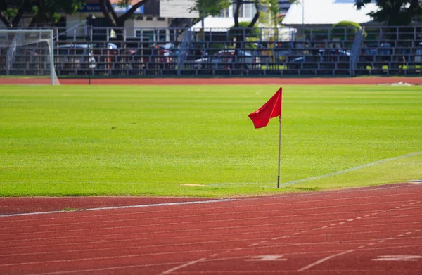 Rudá vlajka na rohu fotbalové hřiště — Stock fotografie