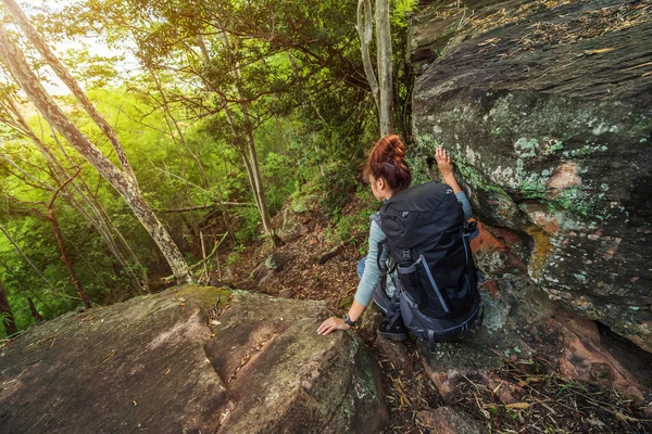 hiker woman climbing down in forest