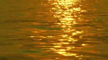 Güneş ışığı yüzeyde günbatımı anda yansıtıyordu. Dalgalar çok romantik ve güzel yüzey taşıma 