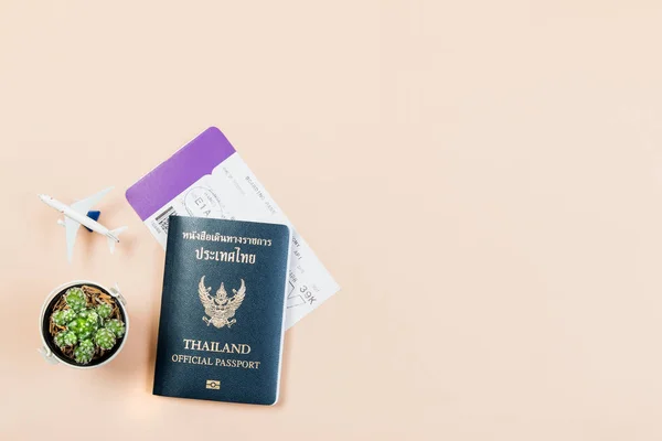 Flat lay e espaço de cópia para o trabalho de design do passaporte oficial da Tailândia, cartão de embarque, cacto pequeno e avião no fundo cor pastel amarelo . — Fotografia de Stock