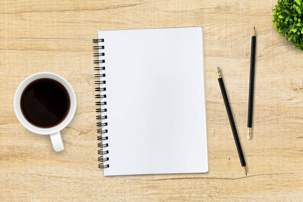 Blank notebook on table. Top view with copy space, flat lay.