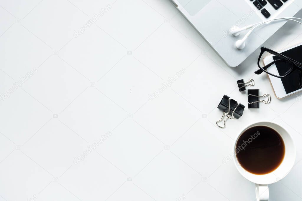 white office desk table with laptop, coffee, and supplies. Top view with copy space, flat lay.