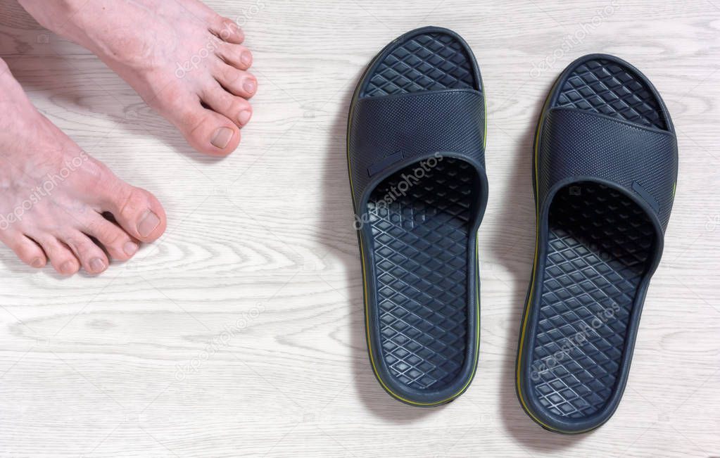 Male Bare Feet and a Pair of Flip Flops