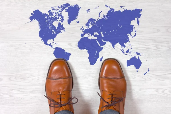 Classic Men\'s Shoes with a World Map Outline on the Floor
