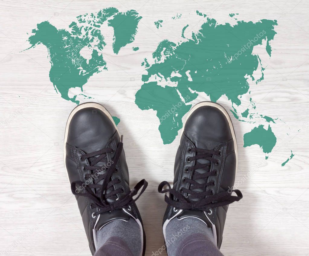 Black Sneakers on a World Map Outline