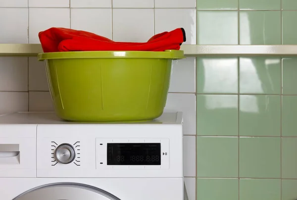 Green Wash Bowl con una sudadera roja dentro en la lavandería —  Fotos de Stock