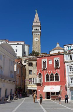 PIRAN, Slovenya - 25 Nisan 2013: Tartini Meydanı 'nın mimarisi St. George' s kilise çan kulesine bakıyor 