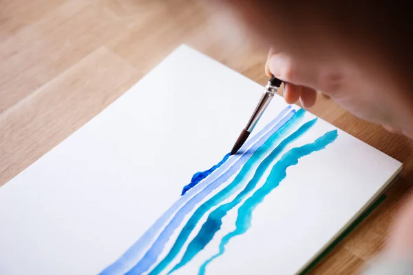Painting with paintbrush on watercolor paper — Stock Photo, Image