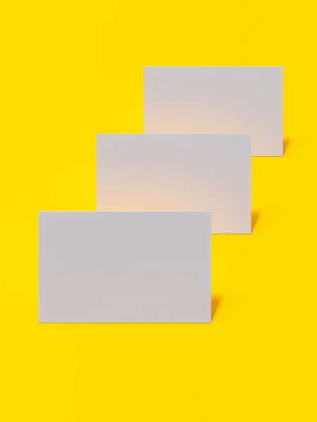 Renderowanie obrazów 3d wizytówek dynamicznie rozrzucone na żółtym tle. — Zdjęcie stockowe