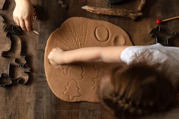 Children play with salt dough on the kitchen table. Hands mold clay with their own hands to create homemade zero-waist toys. Creative lesson with a test of natural products. Development of children in the period of self-isolation.