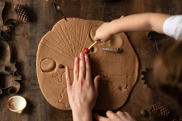 Children play with salt dough on the kitchen table. Hands mold clay with their own hands to create homemade zero-waist toys. Creative lesson with a test of natural products. Development of children in the period of self-isolation.