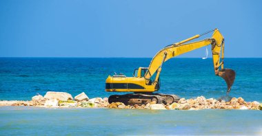 building the jetty with heavy excavator machine clipart