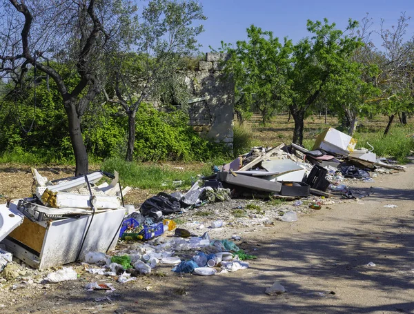 Big problem of environmental degradation. Plastic waste, non-functioning appliances and all kinds of waste left at the edge of a country road.