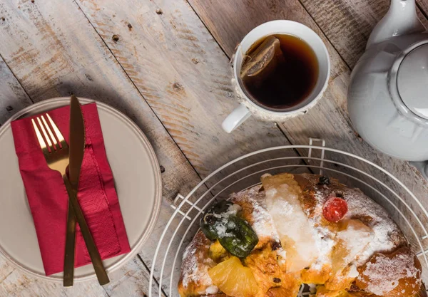 Merry Christmas cake with nuts - Bolo Rei is a traditional Xmas cake with fruits raisins nut and icing on wooden table