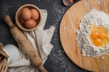Üstten Görünüm yumurta, hamur, un ve ahşap masa arka haddeleme-pin