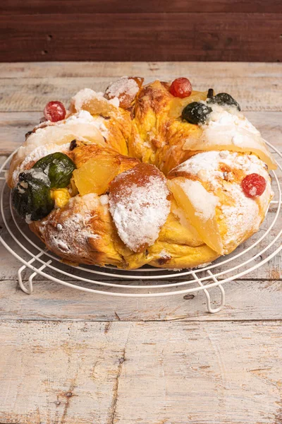Merry Christmas cake with nuts - Bolo Rei is a traditional Xmas cake with fruits raisins nut and icing on wooden table