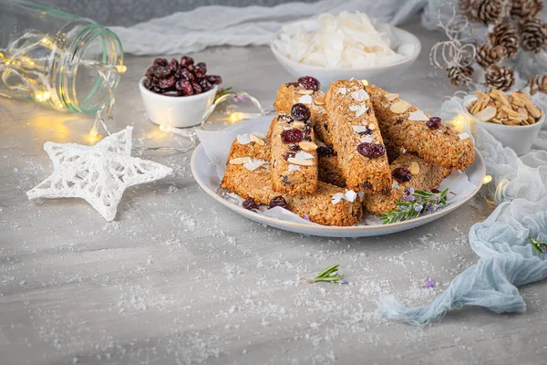Granola bar. Healthy snack. Cereal granola bar with nuts, fruit, coconut and cranberries on a christmas table. — Stock Photo, Image