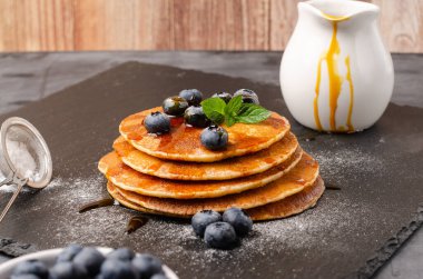 Yaban mersinli ve karamel şuruplu krep yığını.