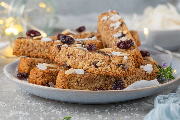 Granola bar. Healthy snack. Cereal granola bar with nuts, fruit, coconut and cranberries on a christmas table.