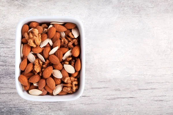 Mixed nuts, view from above of different types. Walnut, hazelnut, almonds and pumpkin seed. — Stock Photo, Image