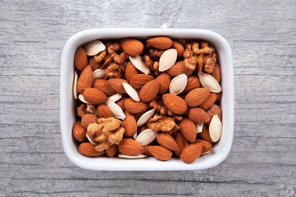 Mixed nuts, view from above of different types. Walnut, hazelnut, almonds and pumpkin seed. — Stock Photo, Image