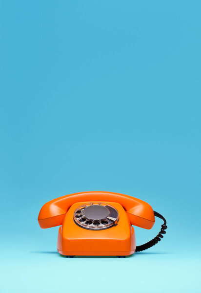 Telephone in retro style on blue background.