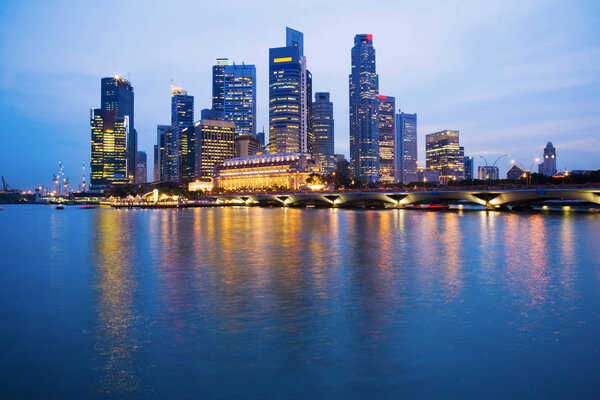 Singapore skyline at twilight reflected in the harbour.