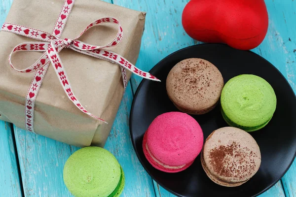 Macaroon cakes in a box and gift, close-up