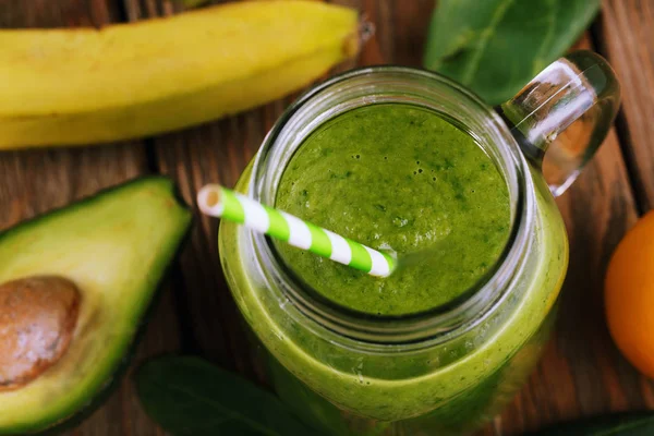 Smoothies of avocado, banana, citrus and spinach leaves. Closeup