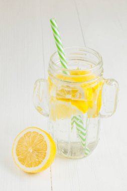 Kaktüs, beyaz bir arka plan üzerine bir bardak limonlu içiyorum.