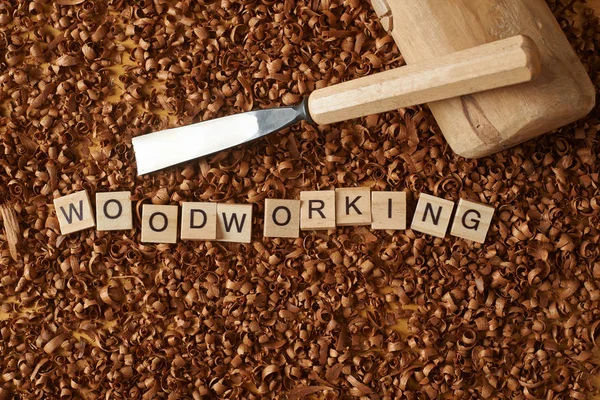 Love woodworking word writen with letters on wood chips with a c — Stock Photo, Image