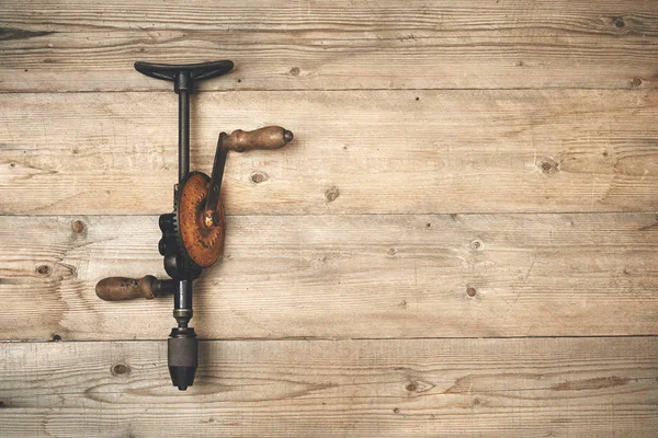 Hand brace drill on a wooden workbench — Stock Photo, Image