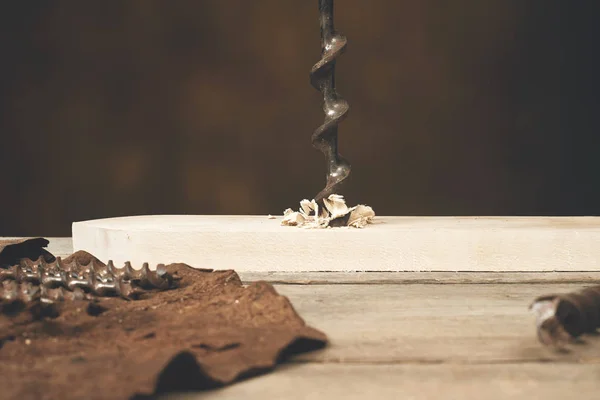 Drilling wood with auger bit on a workbench — Stock Photo, Image